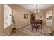 Cozy dining room featuring a round wooden table, chandelier, and an area rug on tile flooring at 474 E Baylor Ln, Gilbert, AZ 85296