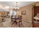 Charming dining area featuring a wooden table, chandelier lighting, and an area rug with tile flooring at 474 E Baylor Ln, Gilbert, AZ 85296