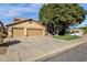 Inviting exterior featuring a spacious driveway, attached garage, and mature landscaping at 474 E Baylor Ln, Gilbert, AZ 85296