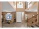 Grand foyer with soaring ceilings, elegant staircase, and abundant natural light at 474 E Baylor Ln, Gilbert, AZ 85296