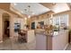 Open kitchen with granite countertops, stainless steel appliances, and an island with bar seating at 474 E Baylor Ln, Gilbert, AZ 85296