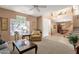 Spacious living room features neutral tones, carpeting, and seamless transition to dining area with tile flooring at 474 E Baylor Ln, Gilbert, AZ 85296