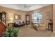 Comfortable living room showcasing neutral decor, plush furniture, and ample natural light from the window at 474 E Baylor Ln, Gilbert, AZ 85296