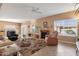 Bright living room featuring tile floors, a fireplace, and views to the dining area at 474 E Baylor Ln, Gilbert, AZ 85296