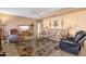 Cozy living room featuring plush seating, a ceiling fan, decorative wall art, and a patterned rug at 474 E Baylor Ln, Gilbert, AZ 85296