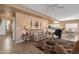 Open-concept living room featuring tile flooring, cozy seating, and seamless flow to the dining area at 474 E Baylor Ln, Gilbert, AZ 85296