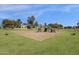 A large playground area with play equipment and benches in a grassy space at 474 E Baylor Ln, Gilbert, AZ 85296