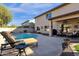 Beautiful backyard pool with lounge chair, patio, and covered outdoor seating area at 474 E Baylor Ln, Gilbert, AZ 85296