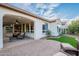 Beautiful backyard featuring a covered patio with a fireplace, artificial turf, and serene outdoor living space at 518 E Laddoos Ave, Queen Creek, AZ 85140