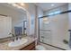 Modern bathroom featuring granite countertops, a glass-enclosed shower, and contemporary fixtures for a spa-like experience at 518 E Laddoos Ave, Queen Creek, AZ 85140