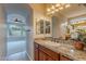 Elegant bathroom featuring granite countertops and a decorative floral arrangement, creating a serene atmosphere at 518 E Laddoos Ave, Queen Creek, AZ 85140