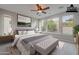 Bright primary bedroom featuring a ceiling fan, natural light, and neutral tones at 518 E Laddoos Ave, Queen Creek, AZ 85140