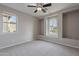 Bright bedroom with a ceiling fan, natural light, and neutral tones, creating a serene and inviting space at 518 E Laddoos Ave, Queen Creek, AZ 85140