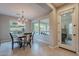 This dining room features a chandelier, natural light, and a view of the backyard at 518 E Laddoos Ave, Queen Creek, AZ 85140