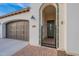 Charming entryway with tiled archway, secured by a wrought iron gate, leads to a welcoming olive-green door at 518 E Laddoos Ave, Queen Creek, AZ 85140