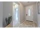 Bright foyer with tile flooring, neutral paint, decorative rug, and a glimpse into adjacent rooms at 518 E Laddoos Ave, Queen Creek, AZ 85140