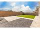 View of the backyard featuring artificial turf and a privacy wall at 5281 S Red Rock St, Gilbert, AZ 85298