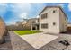 View of the backyard featuring artificial turf, privacy walls, and a covered patio at 5281 S Red Rock St, Gilbert, AZ 85298