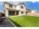 A beautiful home's backyard is showcased, featuring an outdoor living space and artificial turf at 5281 S Red Rock St, Gilbert, AZ 85298