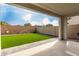 View of the backyard featuring artificial turf, privacy walls, and a covered patio at 5281 S Red Rock St, Gilbert, AZ 85298