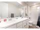 Well-lit bathroom featuring double sinks, white cabinets, framed mirror and decorative accents at 5281 S Red Rock St, Gilbert, AZ 85298