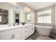 A luxurious main bathroom features double sinks, a vanity and a soaking tub at 5281 S Red Rock St, Gilbert, AZ 85298