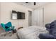 Comfortable bedroom showcasing a TV, cozy seating, closet, and door leading to another area of the home at 5281 S Red Rock St, Gilbert, AZ 85298