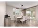 An elegant dining area showcases a modern light fixture and sliding glass doors to the yard at 5281 S Red Rock St, Gilbert, AZ 85298