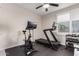 Home gym features a treadmill, stationary bike, free weights, and lots of natural light at 5281 S Red Rock St, Gilbert, AZ 85298