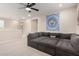 A spacious, light-filled living room features a large sectional sofa and ceiling fan at 5281 S Red Rock St, Gilbert, AZ 85298