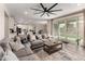 Bright open-concept living room flows into the kitchen featuring an oversized sectional, and sliding doors to the backyard at 5281 S Red Rock St, Gilbert, AZ 85298