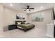 The bright main bedroom showcases a ceiling fan, a bed, and two bedside tables at 5281 S Red Rock St, Gilbert, AZ 85298