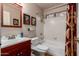 Cozy bathroom with a tub and shower combo, stylish accents, and a vanity, providing a functional and stylish space at 5802 E Fountain St, Mesa, AZ 85205