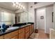 Bathroom with double sinks, granite countertops, and a large framed mirror, offering a blend of style and functionality at 5802 E Fountain St, Mesa, AZ 85205