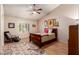 Cozy bedroom with a wooden bed frame, area rug, and a ceiling fan at 5802 E Fountain St, Mesa, AZ 85205