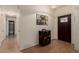 Inviting entryway with hardwood floors, decorative cabinet, and views into the adjacent bathroom at 5802 E Fountain St, Mesa, AZ 85205