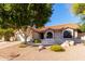 Single-story home with Southwestern architecture, desert landscaping, and a spacious driveway at 5802 E Fountain St, Mesa, AZ 85205