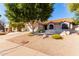 Single-story home with Southwestern architecture, desert landscaping, and a spacious driveway at 5802 E Fountain St, Mesa, AZ 85205