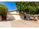 A one-story home with a two-car garage and low maintenance landscaping at 5802 E Fountain St, Mesa, AZ 85205