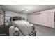 Spacious garage featuring an antique car, ample storage, and an automatic door, combining utility and classic charm at 5802 E Fountain St, Mesa, AZ 85205