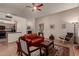 Open-concept living room with hardwood floors, a ceiling fan, and a glimpse of the kitchen at 5802 E Fountain St, Mesa, AZ 85205