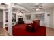 Relaxing living room featuring cozy seating, a ceiling fan, and plush red carpeting at 5802 E Fountain St, Mesa, AZ 85205