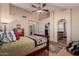 Inviting main bedroom featuring archway to bath, walk in closet, and ceiling fan at 5802 E Fountain St, Mesa, AZ 85205