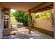 Covered back patio with concrete pavers and mature citrus trees provides a relaxing outdoor space at 653 S Catalina St, Gilbert, AZ 85233