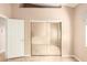 Bedroom featuring mirrored closet doors and access to another room at 653 S Catalina St, Gilbert, AZ 85233