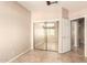 Bedroom with mirrored closet and tiled floors, leading to another room at 653 S Catalina St, Gilbert, AZ 85233