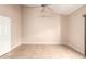 An empty bedroom featuring vaulted ceilings, tile floors, and a ceiling fan at 653 S Catalina St, Gilbert, AZ 85233