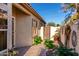 Side exterior of house featuring private entrance, plants, and tiled walkway at 653 S Catalina St, Gilbert, AZ 85233