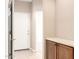 Hallway with white trim, wood cabinets and a view to a white front door at 653 S Catalina St, Gilbert, AZ 85233