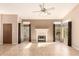 Spacious living room featuring a cozy fireplace, neutral walls, tile flooring and plenty of natural light at 653 S Catalina St, Gilbert, AZ 85233